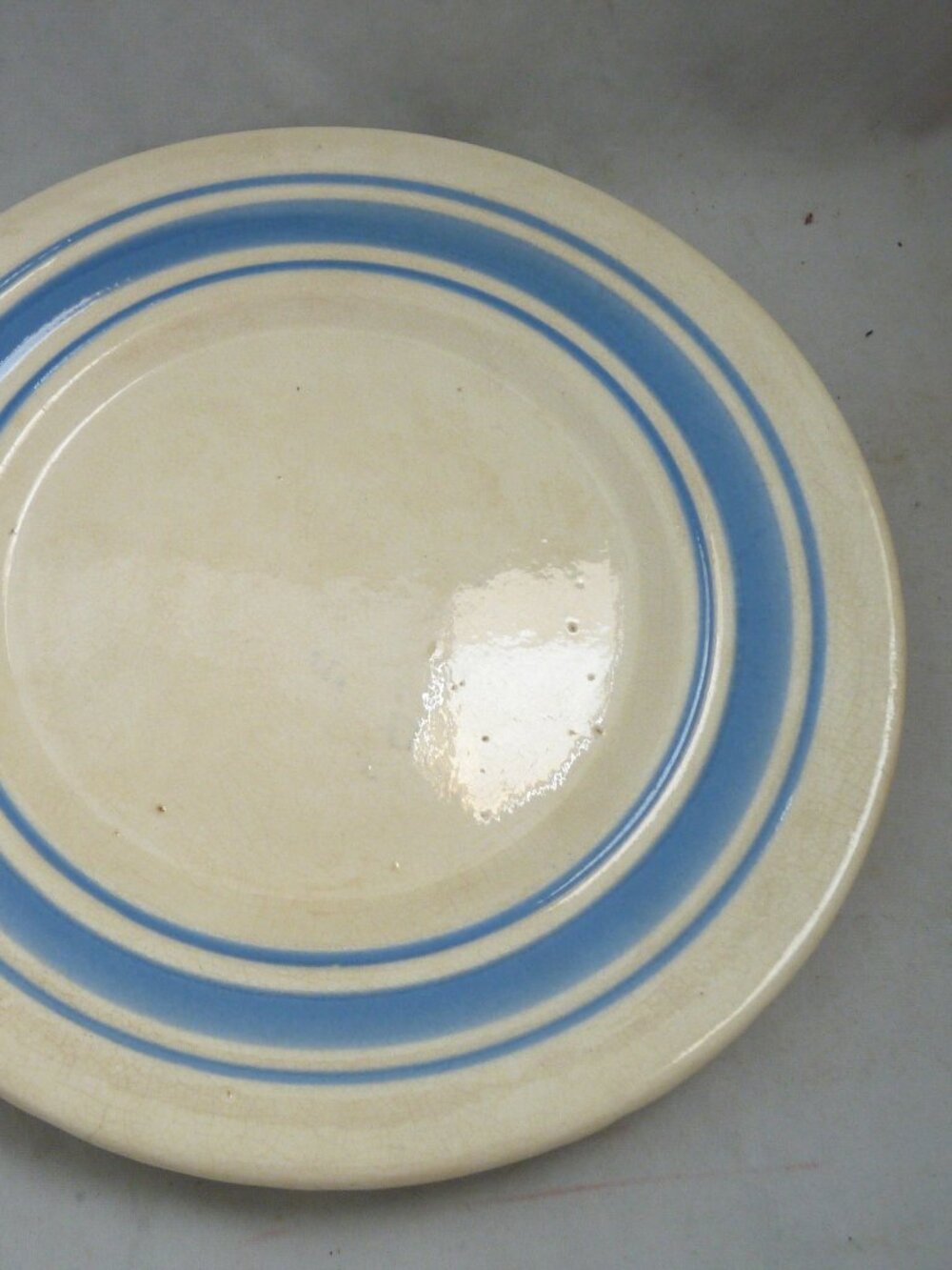 Antique stoneware plate blue bands white